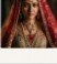 Bridal portrait in red ceremonial lehenga and gold maang tikka
