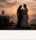 Romantic sunset silhouette of bride and groom in the hills
