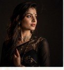 Studio fine-art portrait with sculptural lighting on ethnic attire
