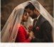 Couple under translucent bridal veil at twilight ceremony
