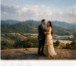 Pre-wedding couple overlooking green misty valley at sunset